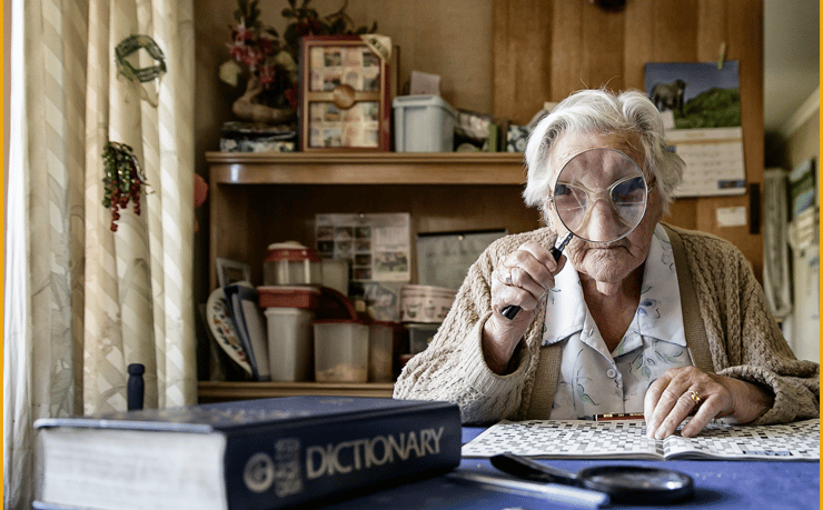 Close up of Elsie looking through her magnifying glass
